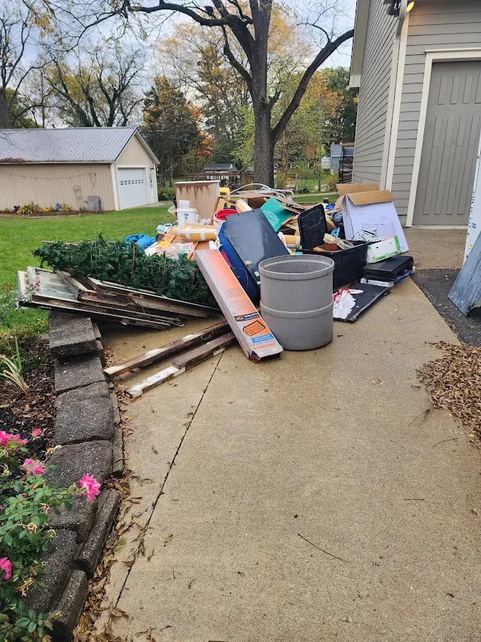 Dumpster being loaded with debris for Estate Cleanout Dumpster Rental in Aston